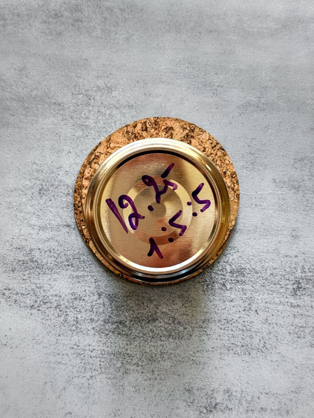 Overhead view of a sourdough starter jar with a marked lid.