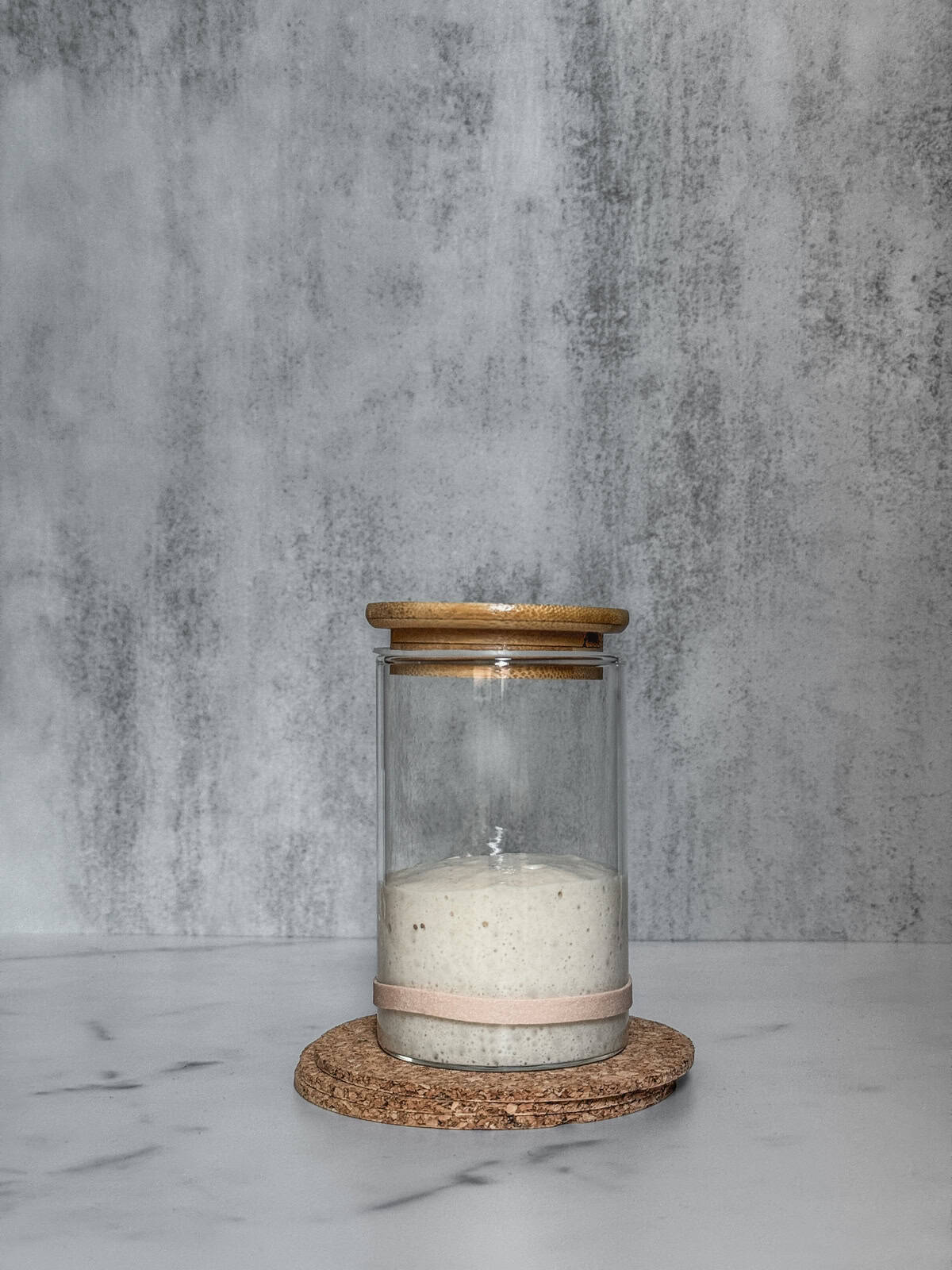 Jar of sourdough starter on day 5 morning, front view.