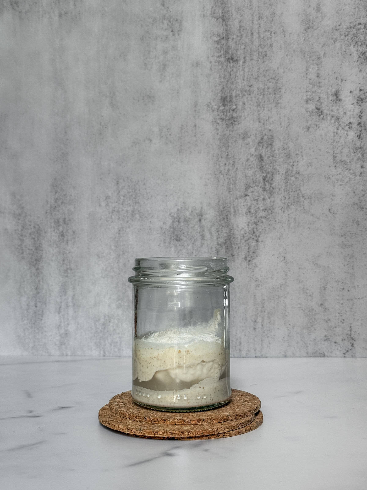 Starter, flour and water in a jar, not mixed yet.