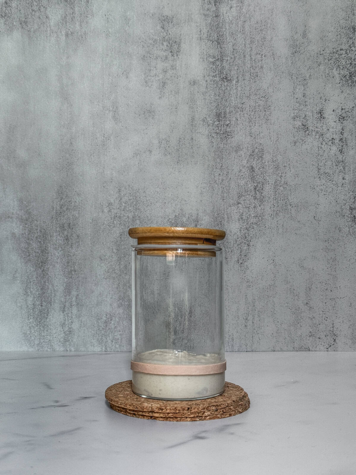 Jar of sourdough starter on day 4 morning after mixing, front view.