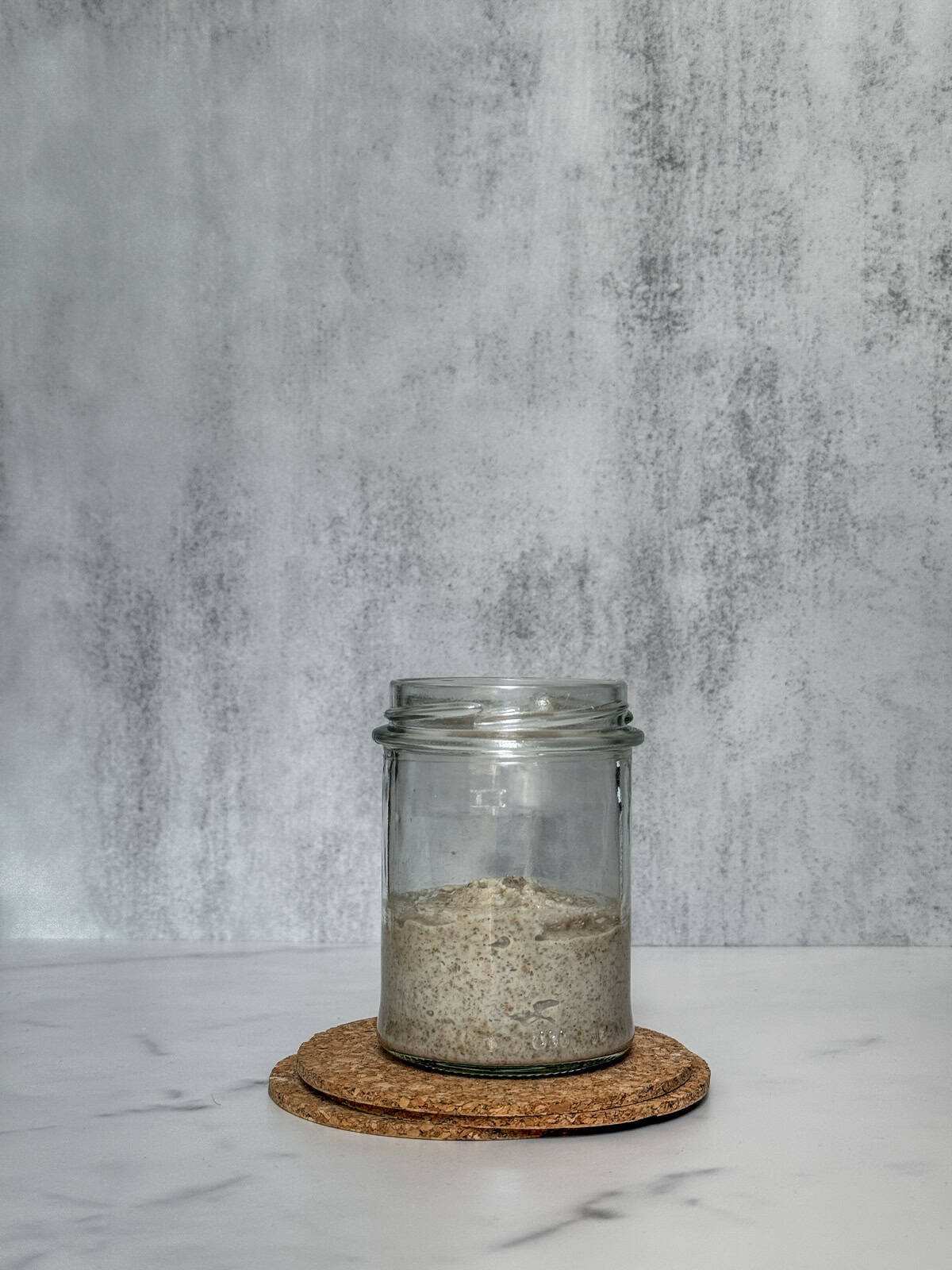 Starter ingredients combined in a jar (front view).