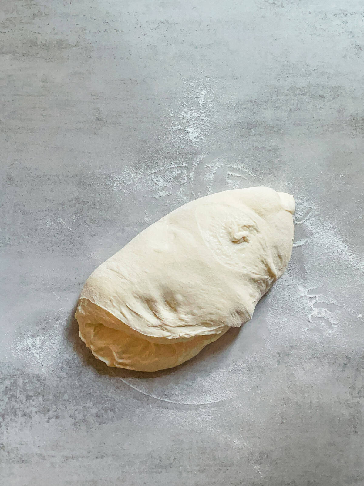 Sourdough dough being folded for preshaping.
