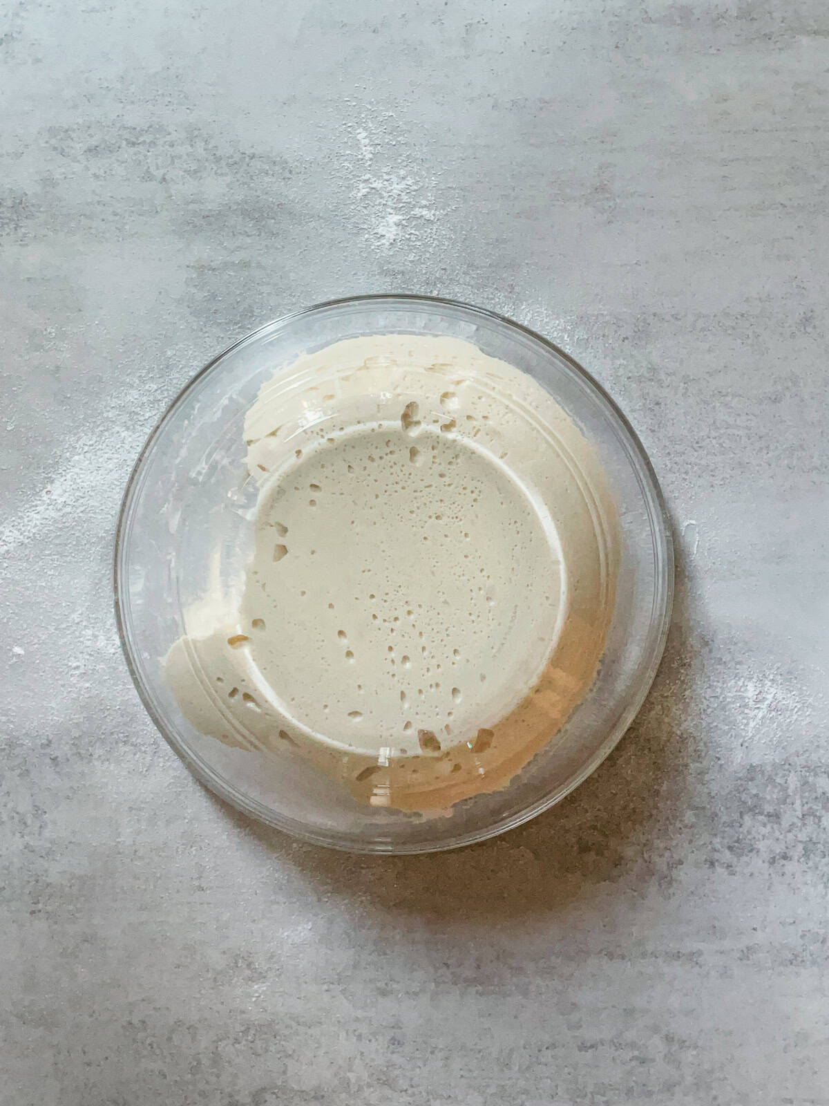 Sourdough being released from a glass bowl.