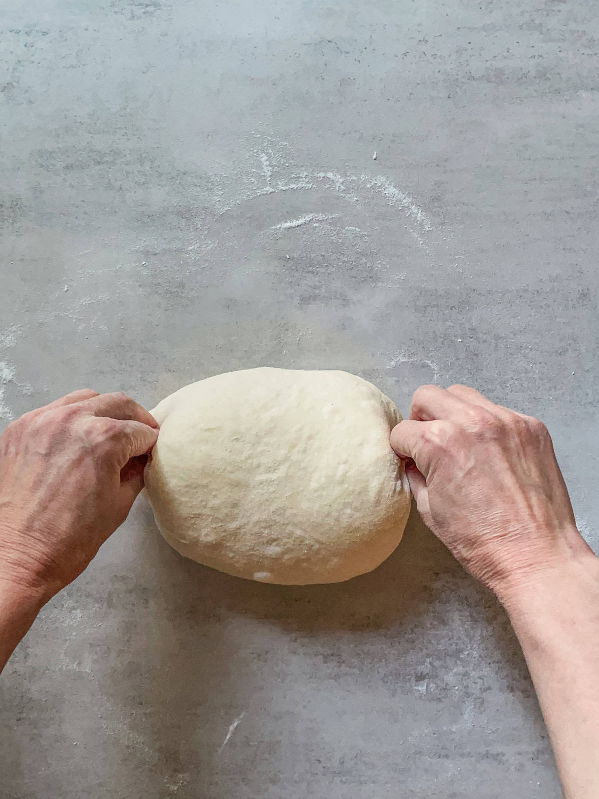 Hans pinching the ends of the dough.
