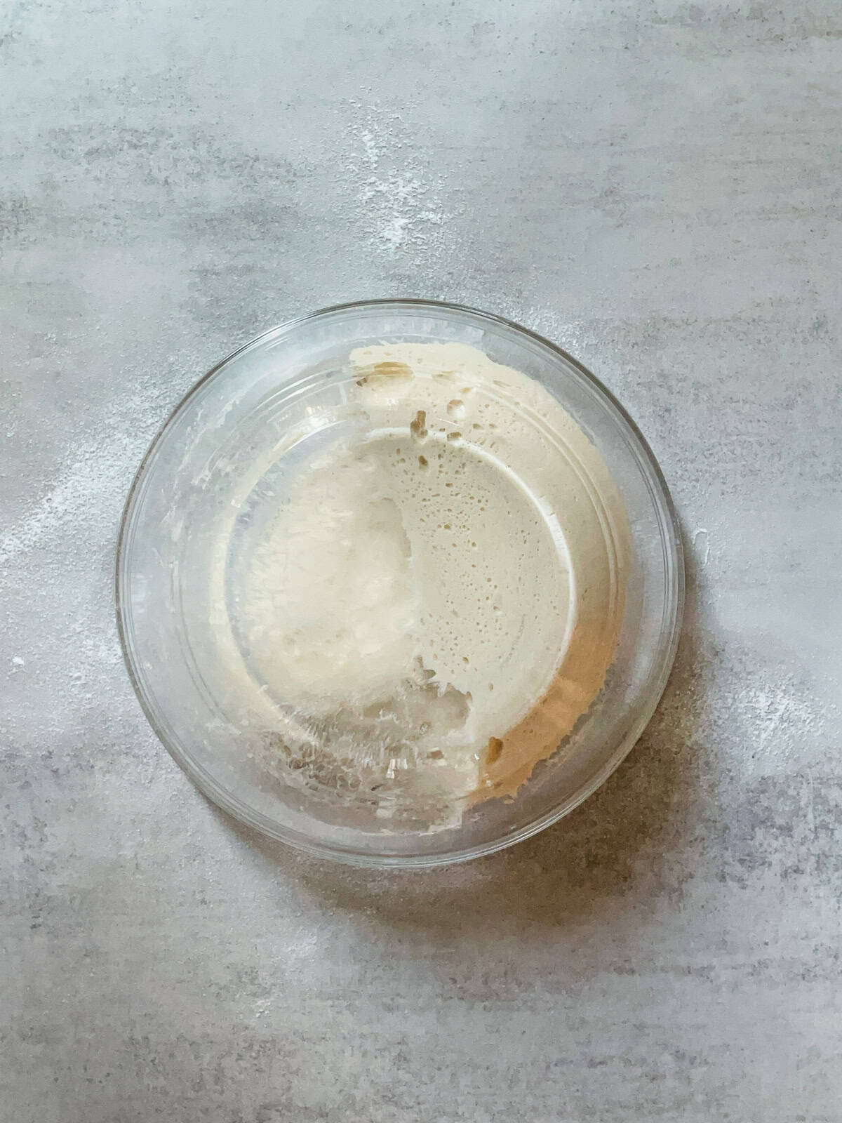 Fermented dough being released from a bowl.