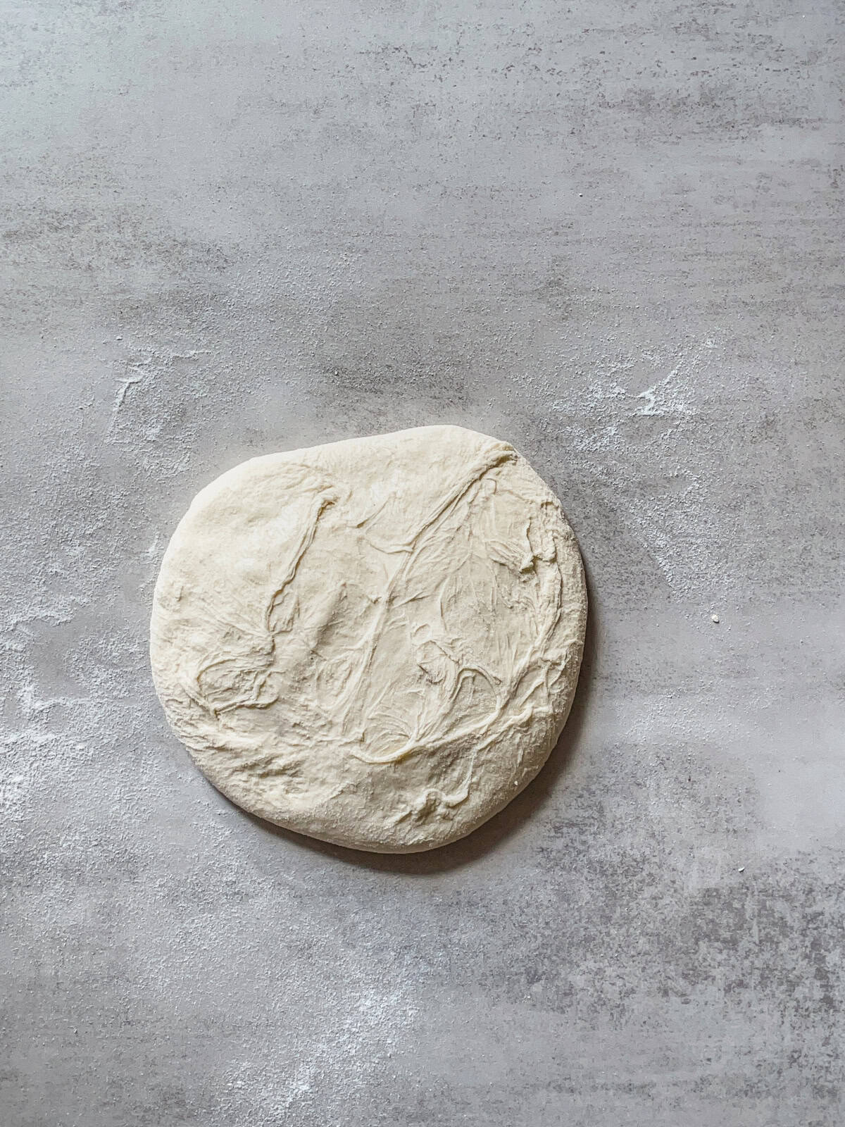 Sourdough dough flipped onto a table.