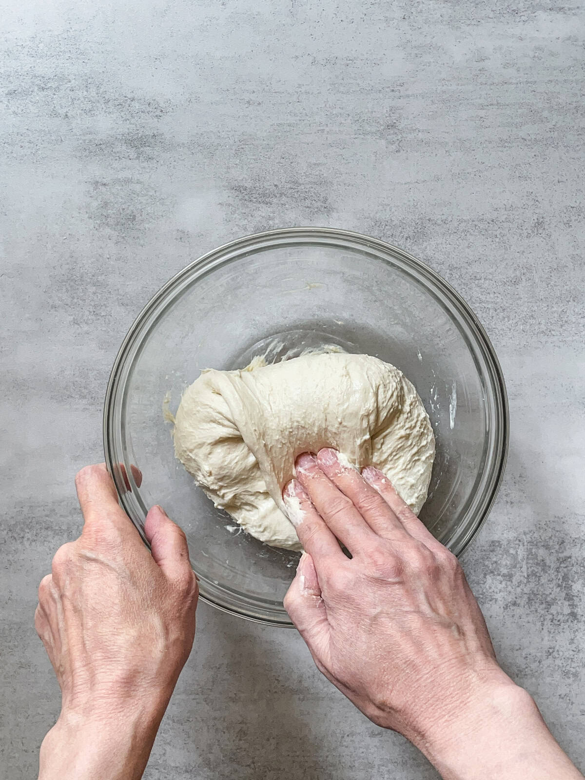 Hand folding the dough during stretch and folds.