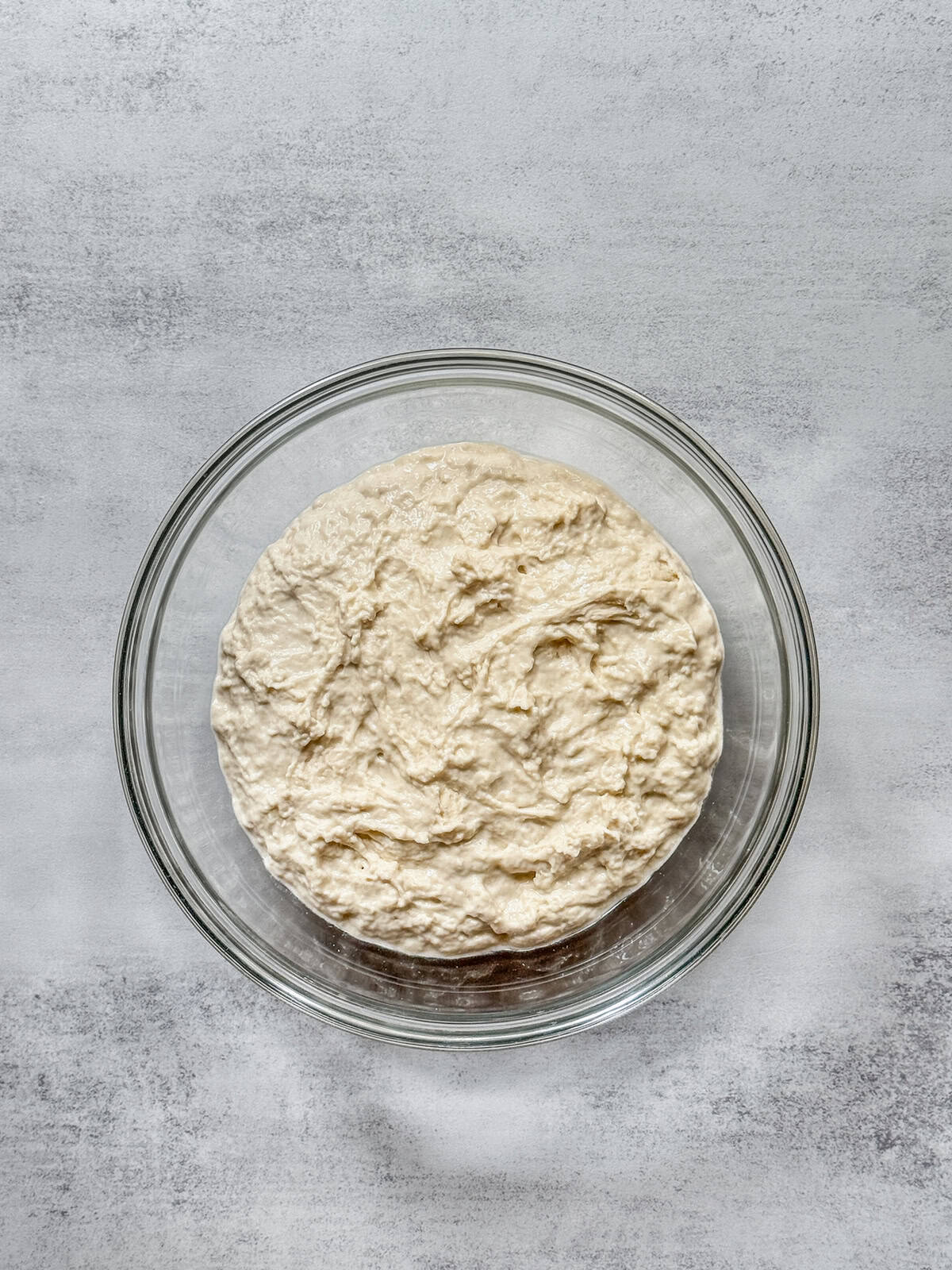 Sourdough dough mixture in a glass bowl during fermentolyse.