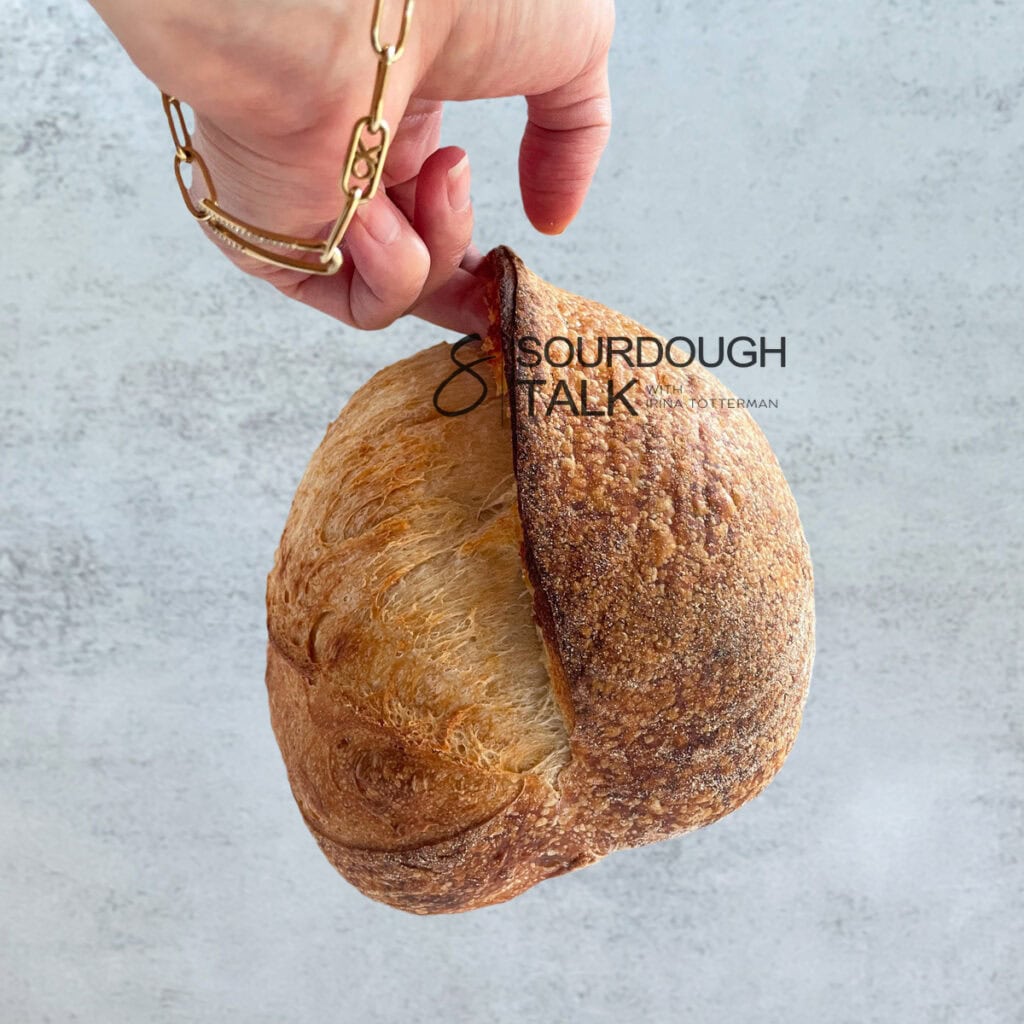 Close-up of a sourdough loaf with a lifted sourdough ear.