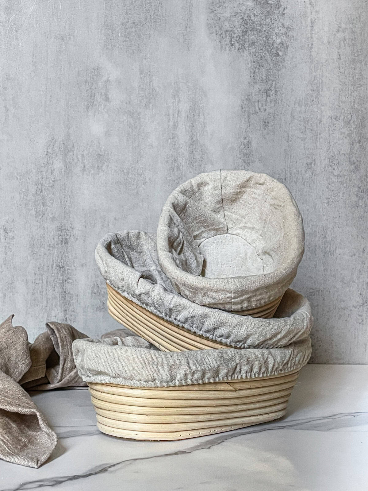 Several banneton baskets in different sizes stacked inside one another.
