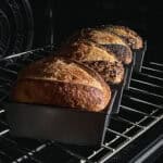 Sourdough bread in loaf pans in the oven.