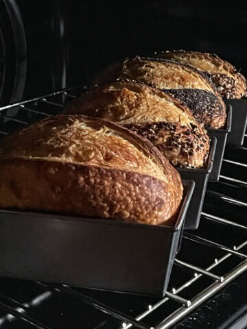 Sourdough bread in loaf pans in the oven.