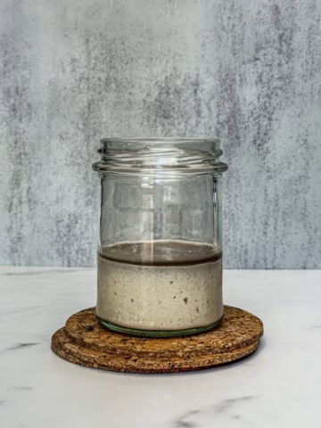 Neglected sourdough starter with hooch on top.