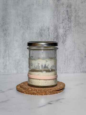 Jar of deflated, neglected sourdough starter.