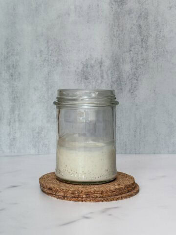 Acidic sourdough starter in a jar.