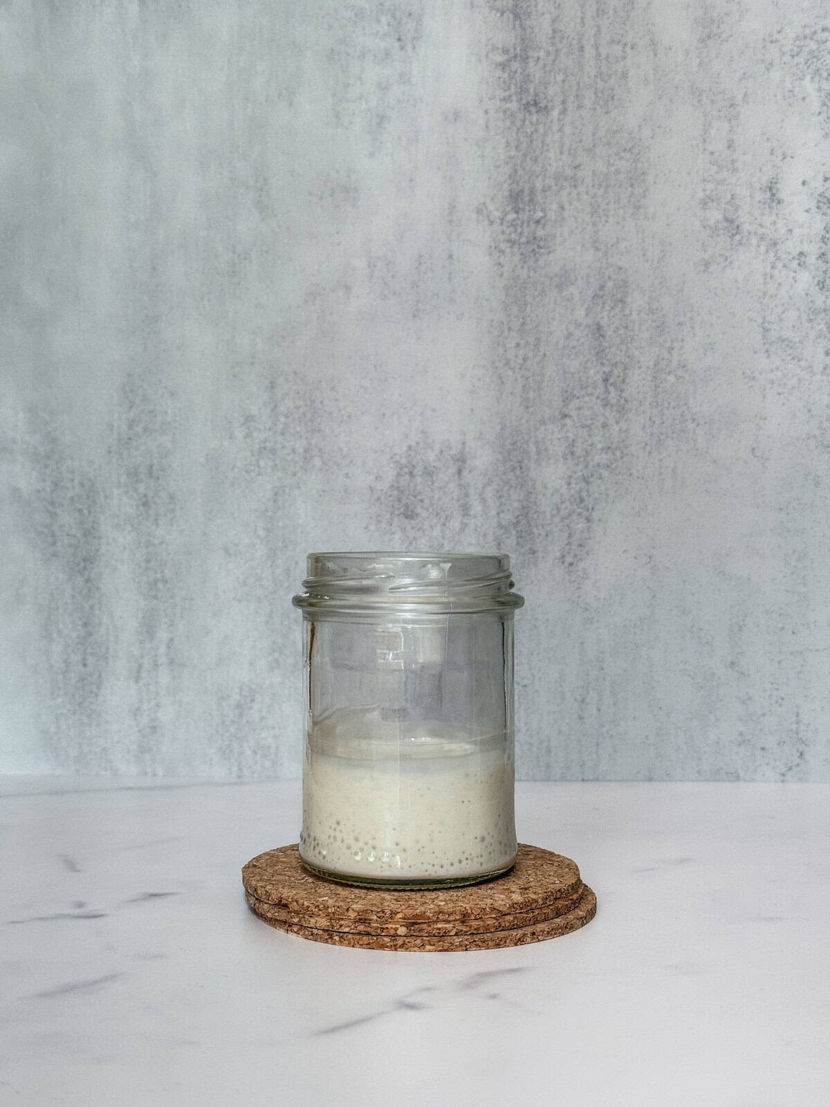 Weak, acidic sourdough starter in a jar.