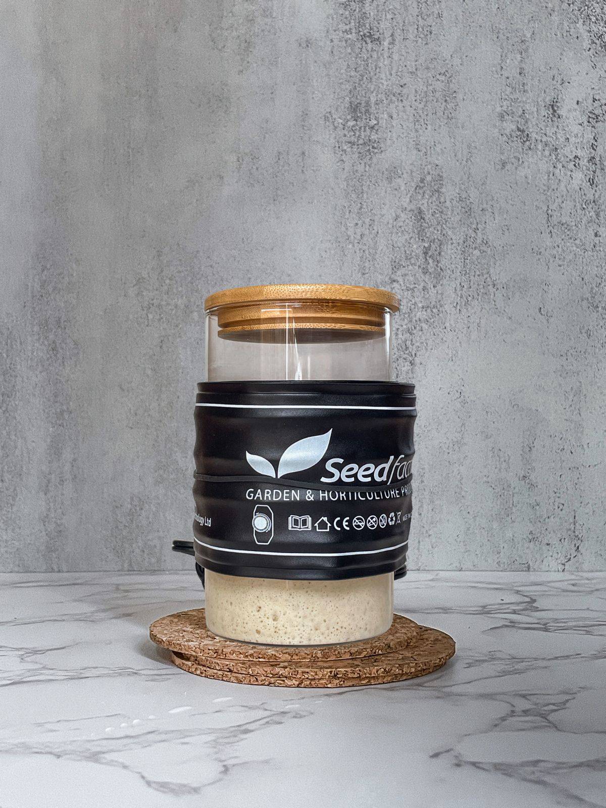 Sourdough starter jar wrapped with a seed-heated mat.