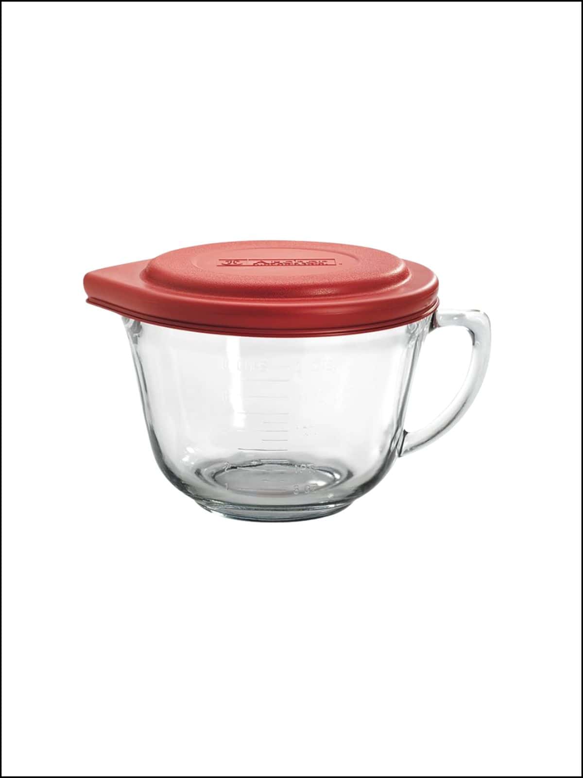 Large glass measuring cup with a lid.