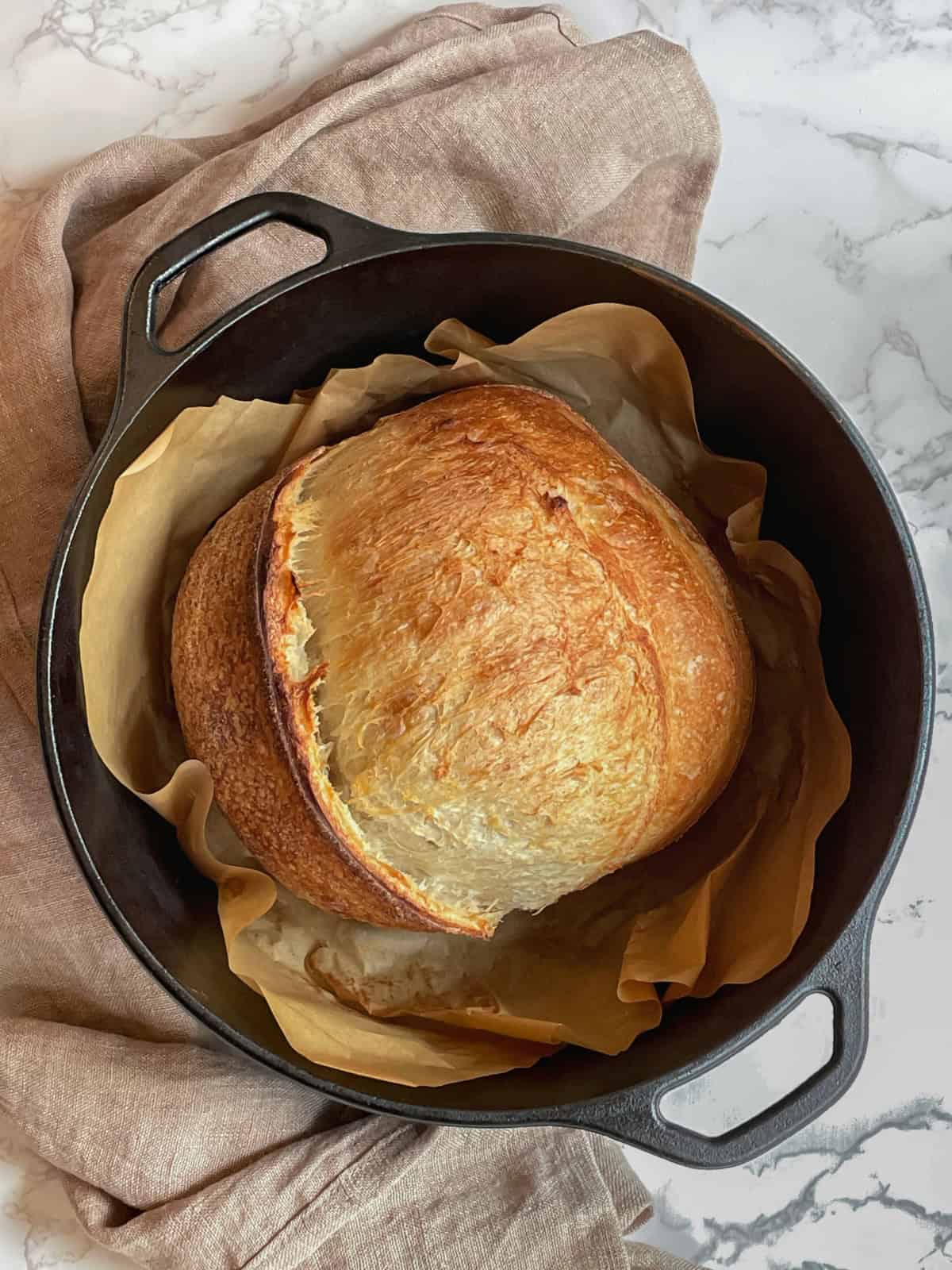 Easy unloaf sourdough bread in a Dutch oven.