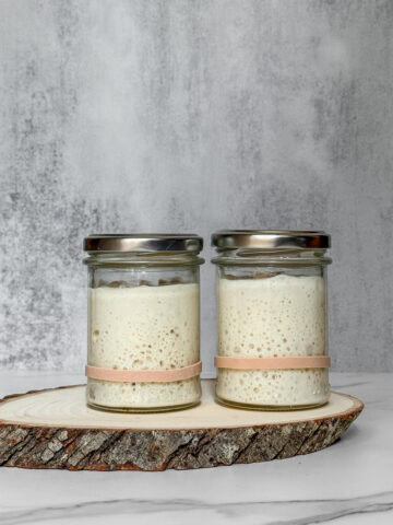 Two jars showing a liquid vs. stiff sourdough starter comparison.