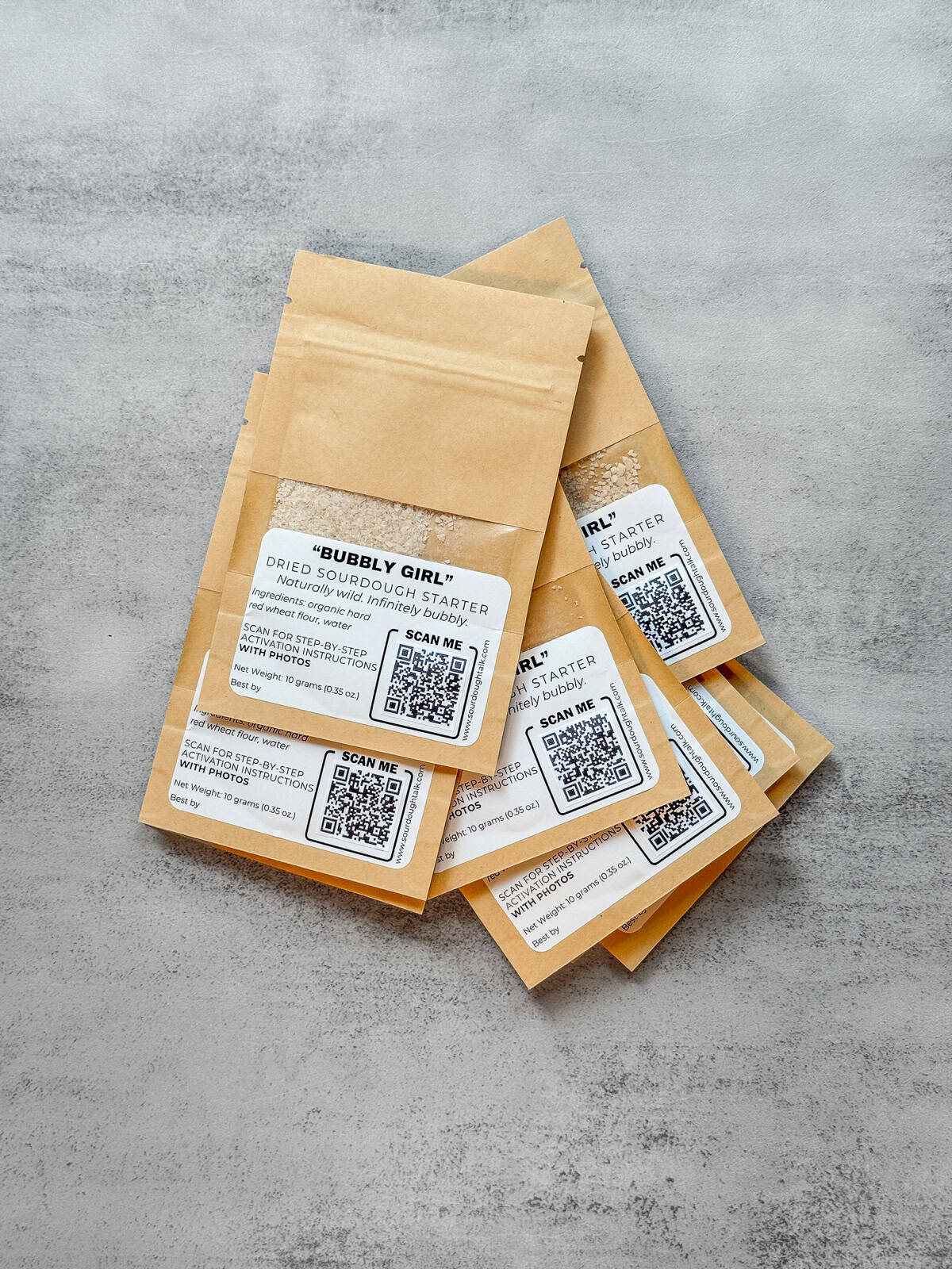 Multiple kraft paper bags of dried sourdough starter.