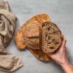 Halved Guinness sourdough bread held in hand.