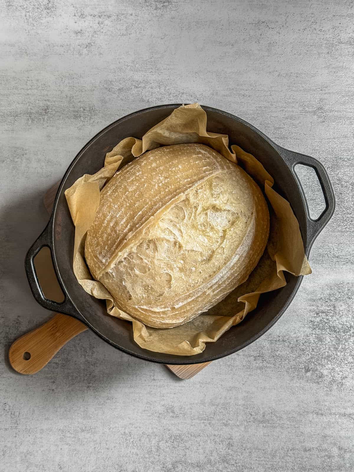 Parbaked sourdough bread in a Dutch oven.