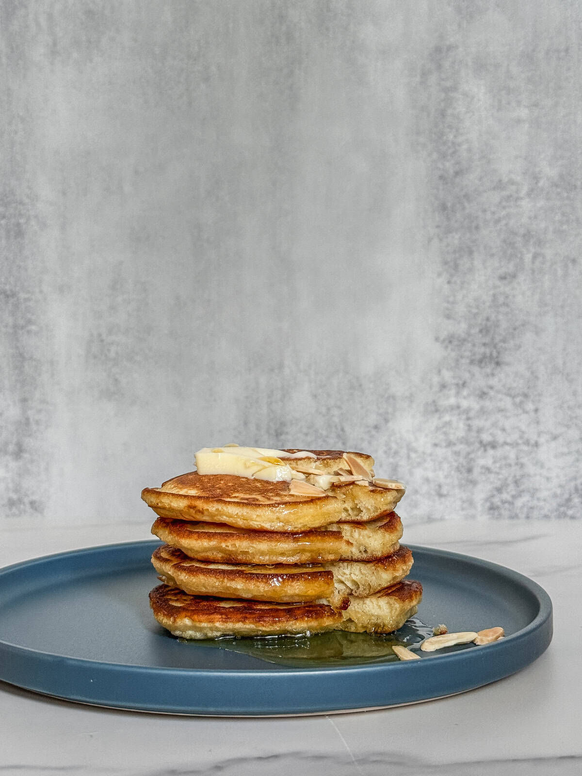 Sourdough discard pancakes with butter and honey on top.