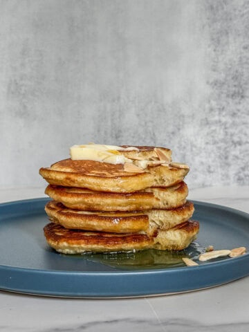Sourdough pancakes with butter and honey on top.