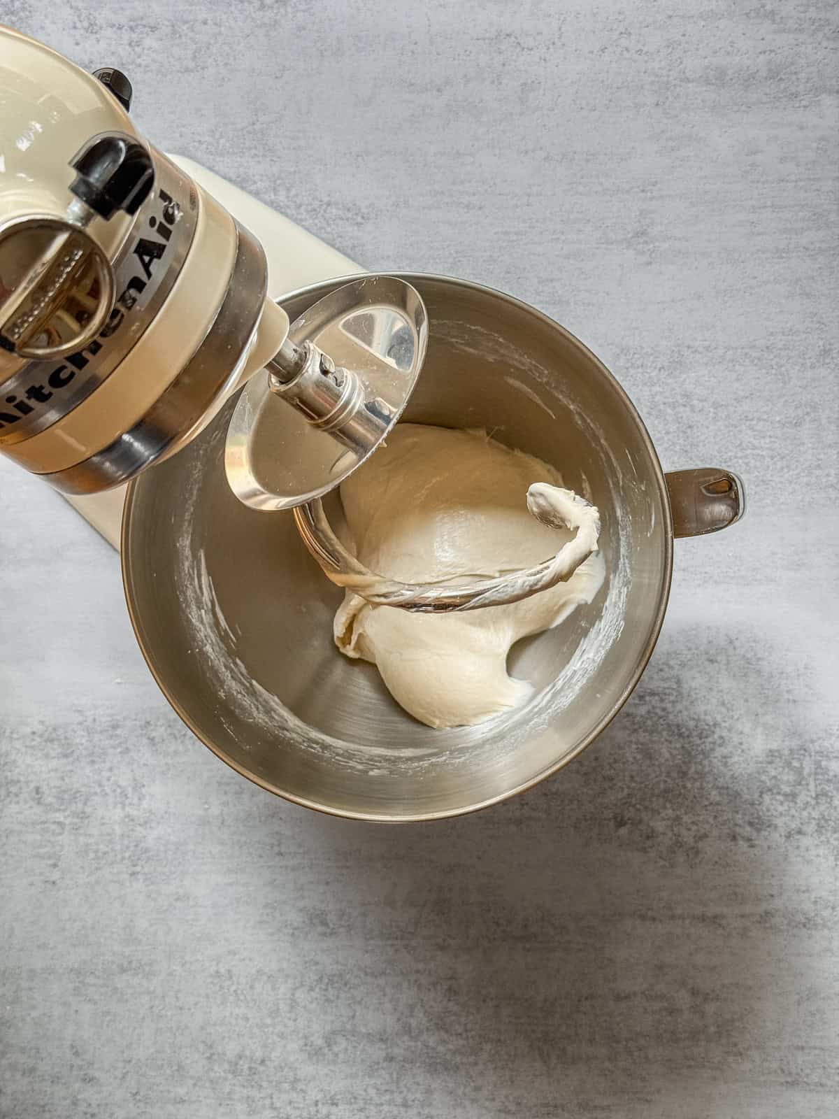 Sourdough dough in a stand mixer bowl after adding salt.