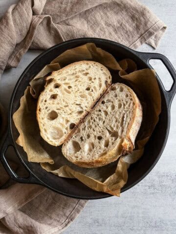 Halved stand mixer sourdough bread in a Dutch oven.