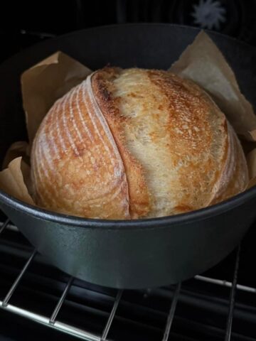 Sourdough bread in a Dutch oven with sourdough scoring.