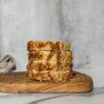 Sliced sourdough banana bread on a serving board.