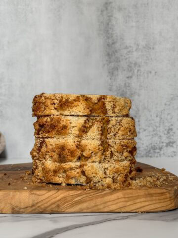 Sliced sourdough banana bread on a serving board.
