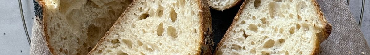 Sourdough loaves cut open, showing crumbs' structure.